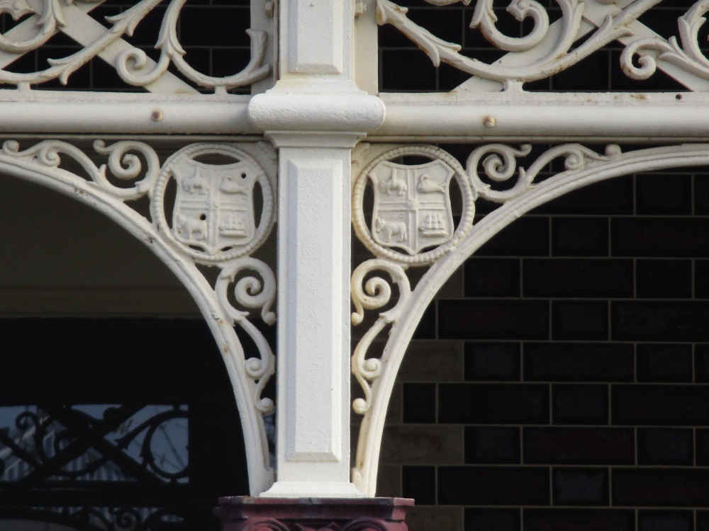Melbourne City Council coat of arms on shopfront verandah iron lacework in Canning Street North Carlton