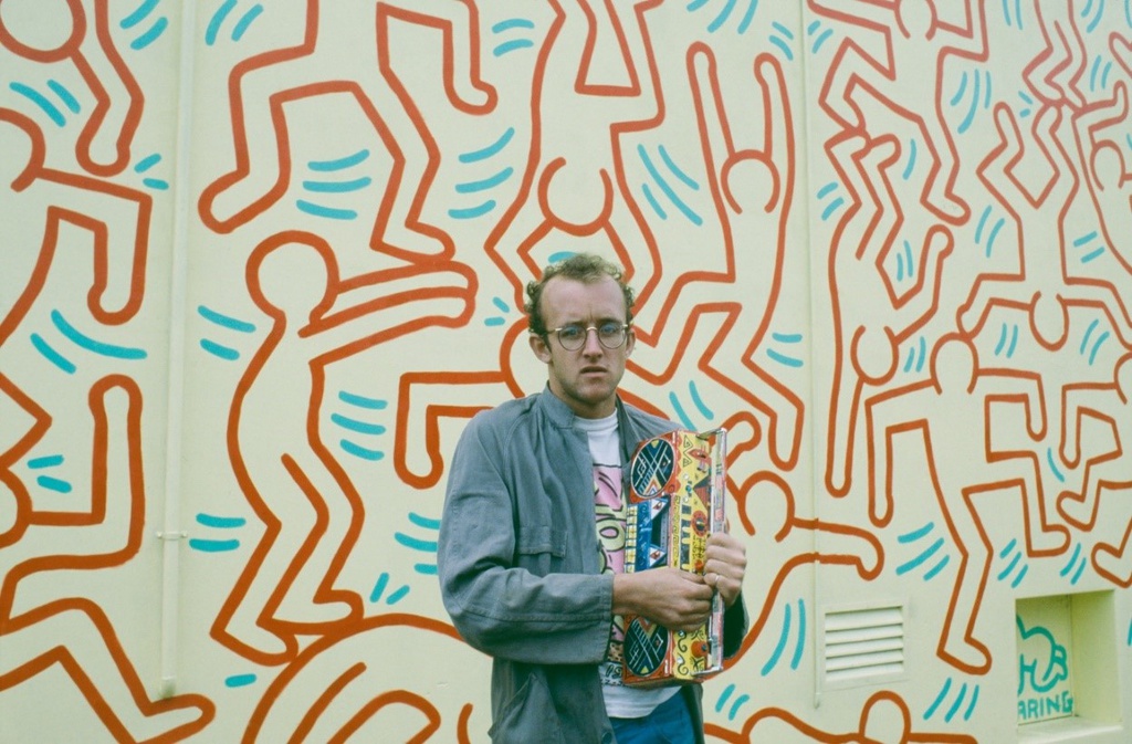 Keith Haring in front of his mural, 1984